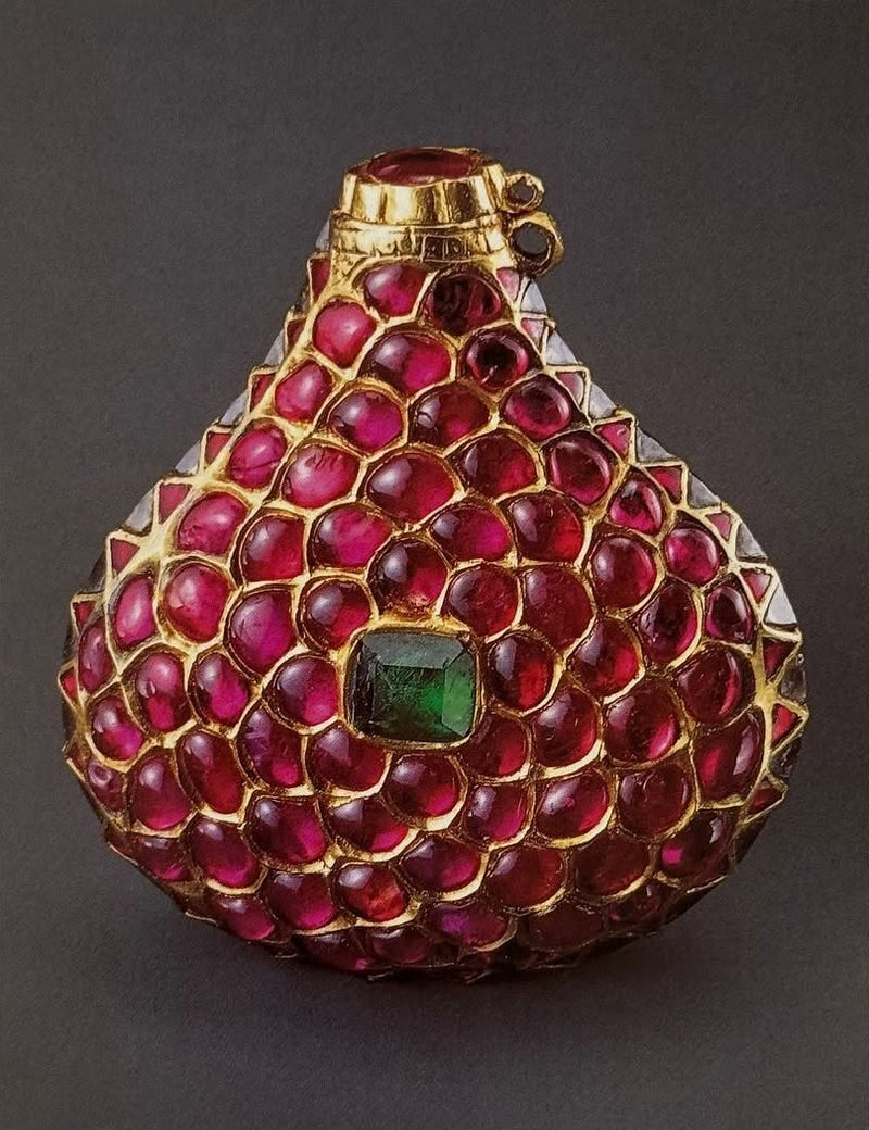 A flask set all over with rubies and an emerald in gold