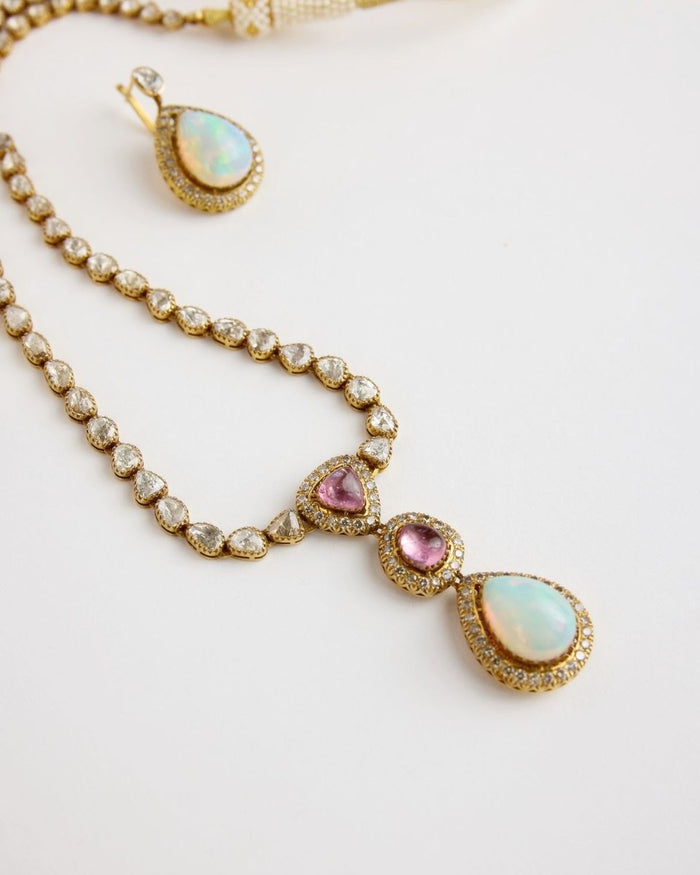 A necklace of polki ending in an opal pendant